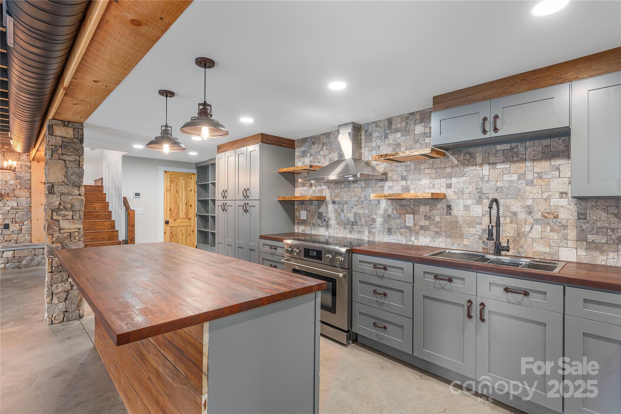 234 Erwin Hills Road Asheville, NC 28806 - Photo 34 of 47 a kitchen with kitchen island a sink stove and refrigerator