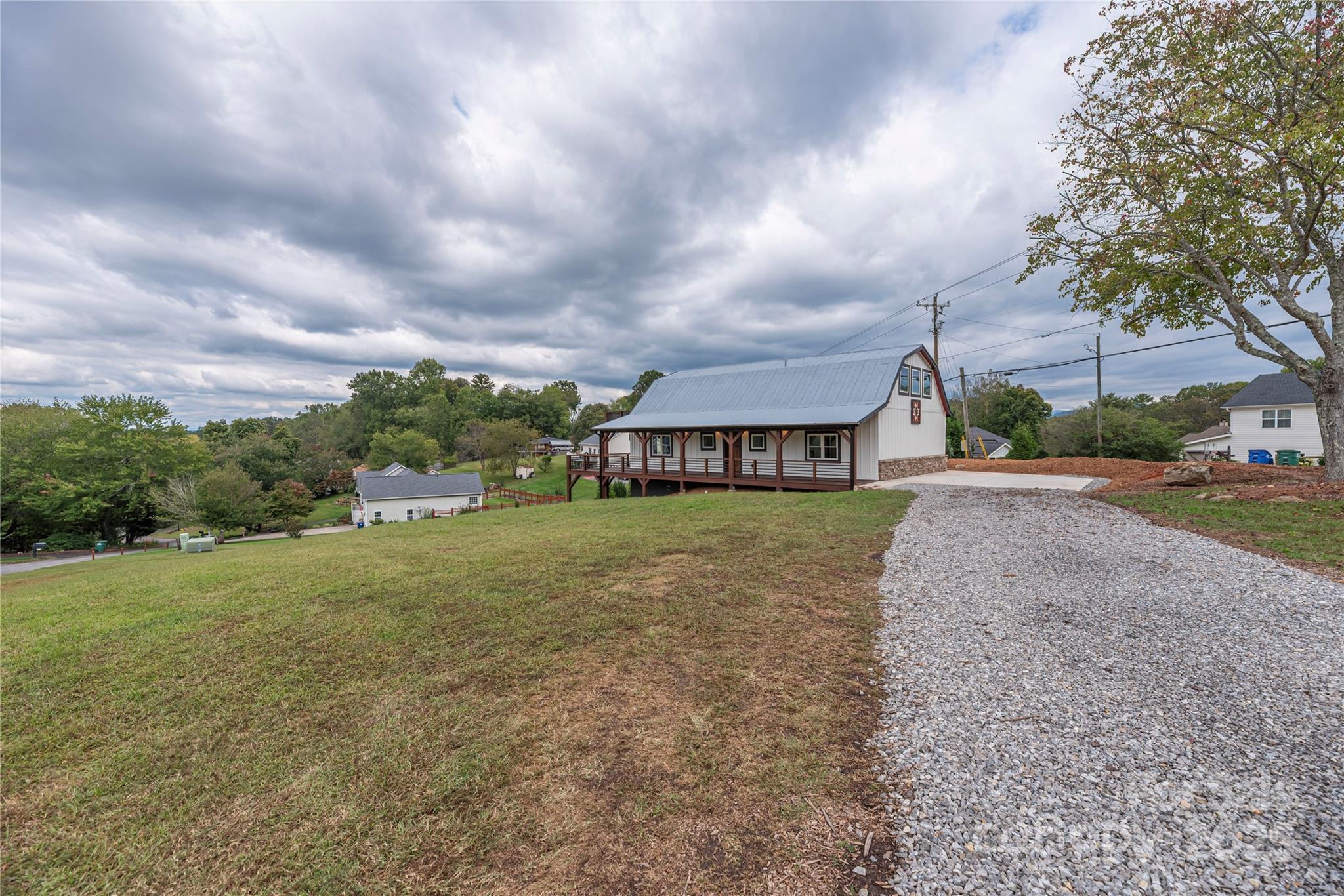 234 Erwin Hills Road Asheville, NC 28806 - Photo 4 of 47 a view of a big house with a big yard and large trees