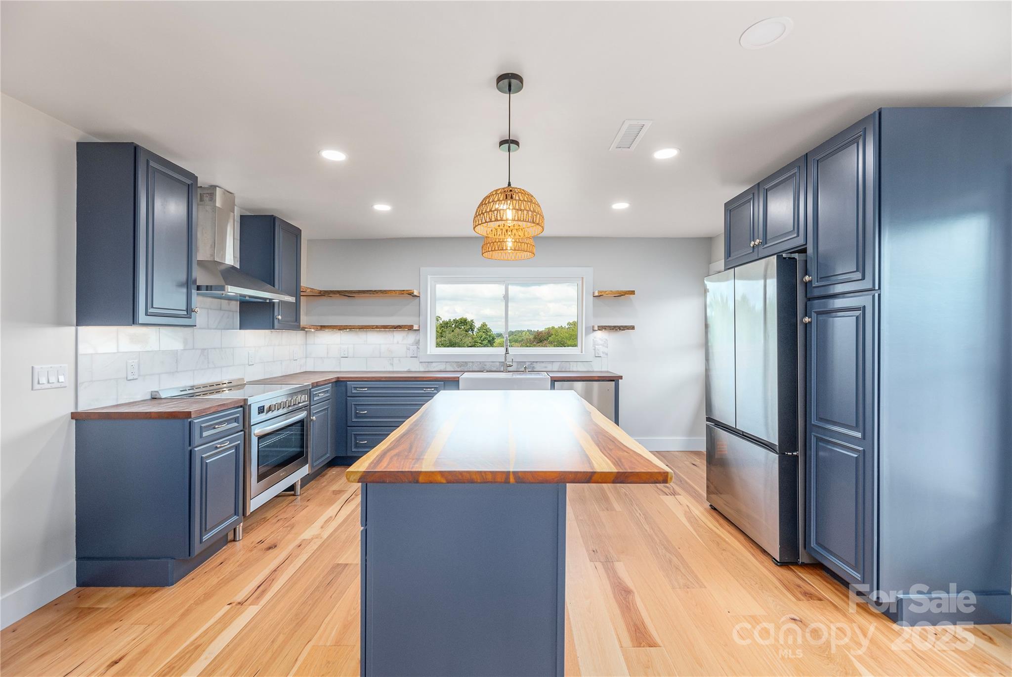 234 Erwin Hills Road Asheville, NC 28806 - Photo 10 of 47 a kitchen with stainless steel appliances granite countertop a sink and a refrigerator
