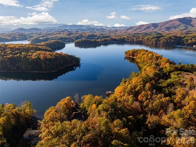 a view of a kitchen with wooden floor and a window