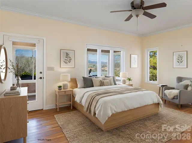 a view of a patio with table and chairs potted plants with floor to ceiling window and potted plants