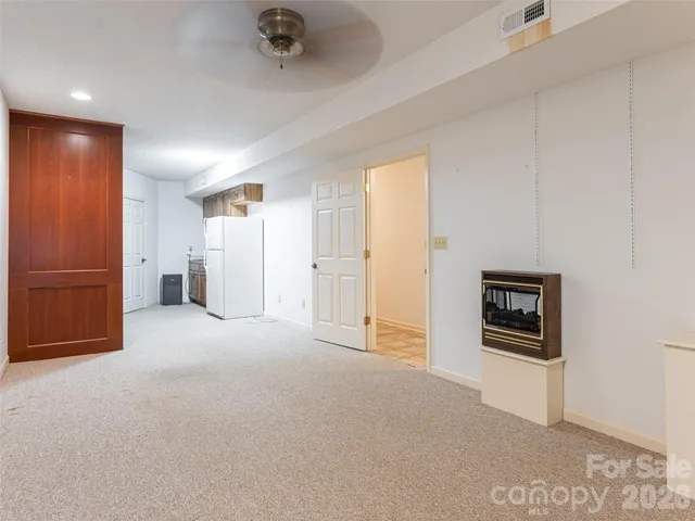 a patio with tables and chairs under an umbrella