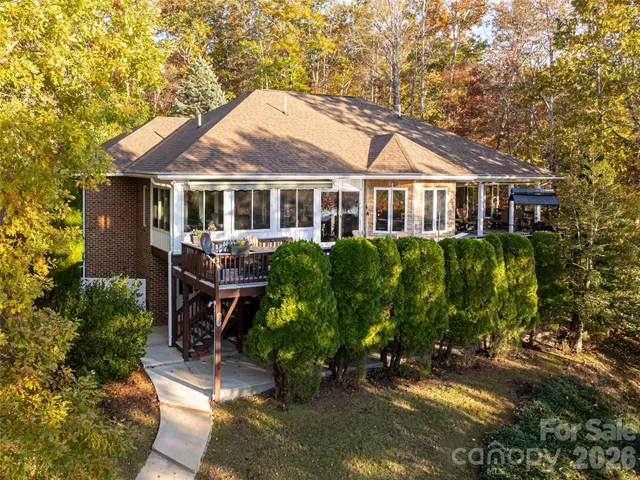 a view of deck with furniture and trees