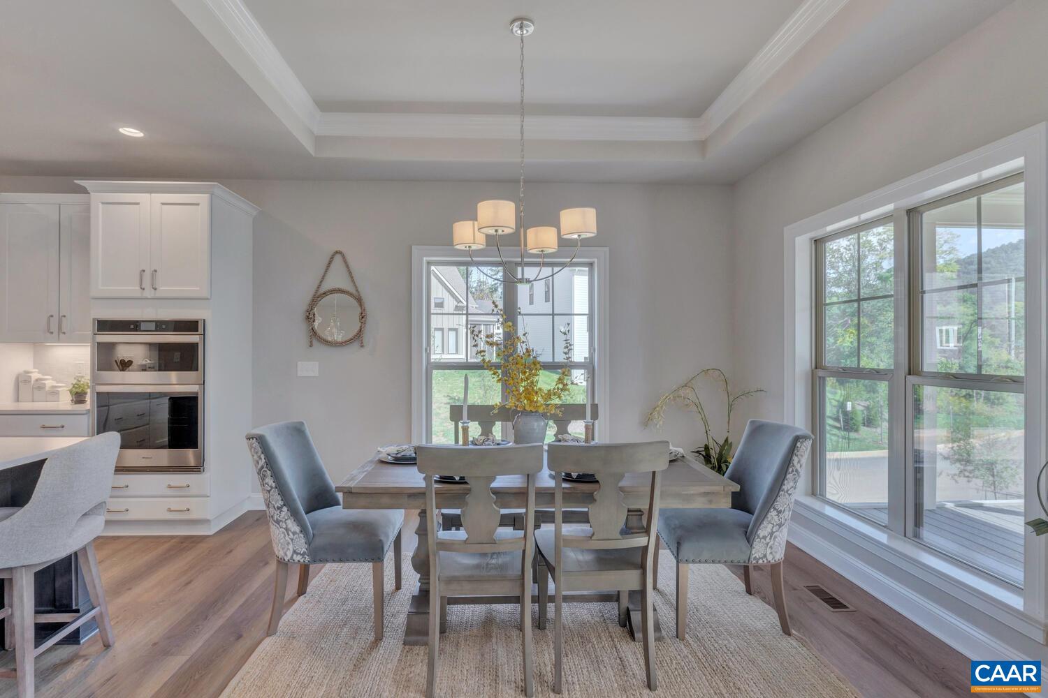 115 Riparian Court, Unit B Charlottesville, VA 22911 - Photo 14 of 58 a dining room with furniture a chandelier and wooden floor