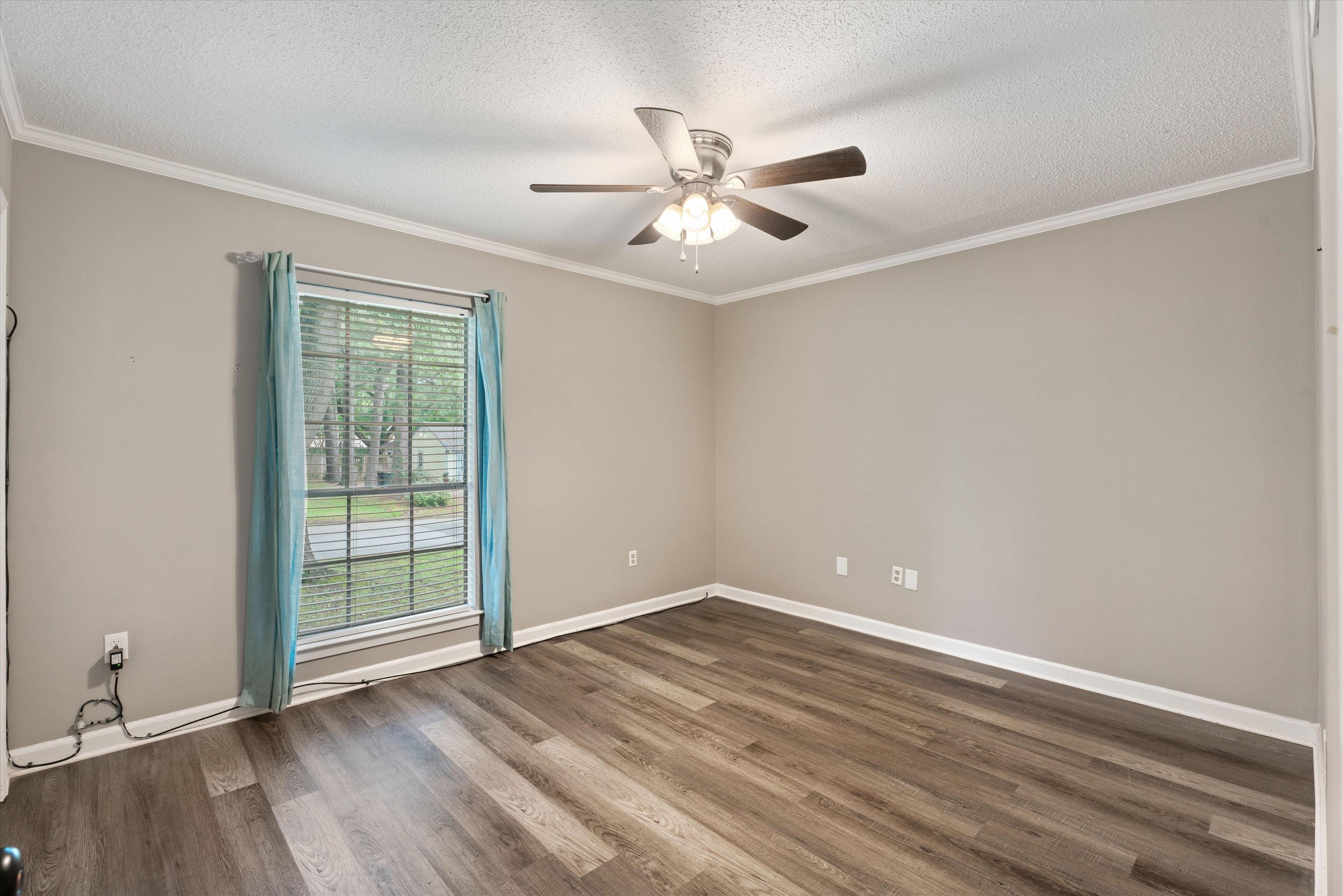 960 Greenview Road Collierville, TN 38017 - Photo 14 of 23 an empty room with wooden floor fan and windows