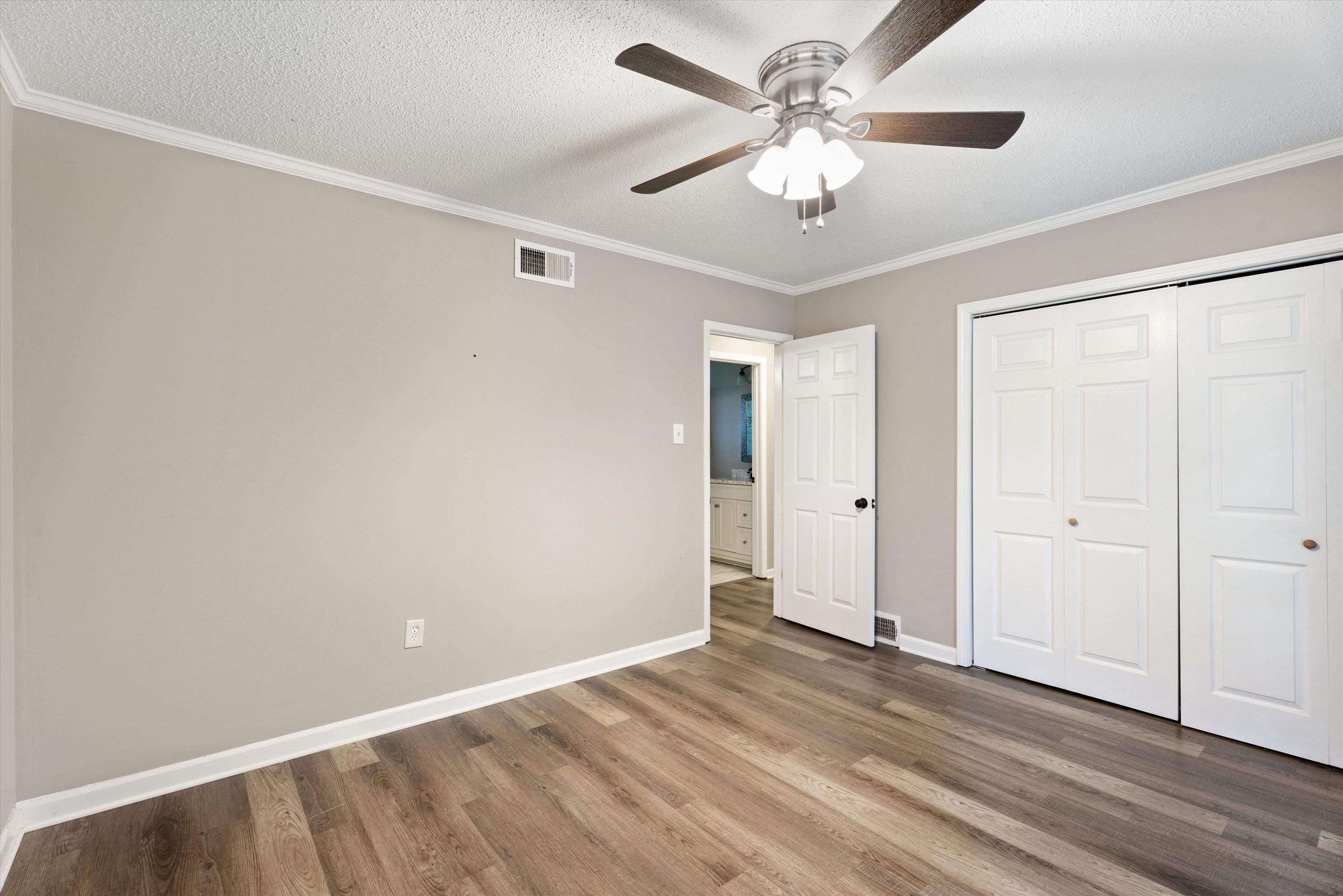 960 Greenview Road Collierville, TN 38017 - Photo 15 of 23 an empty room with wooden floor and ceiling fan