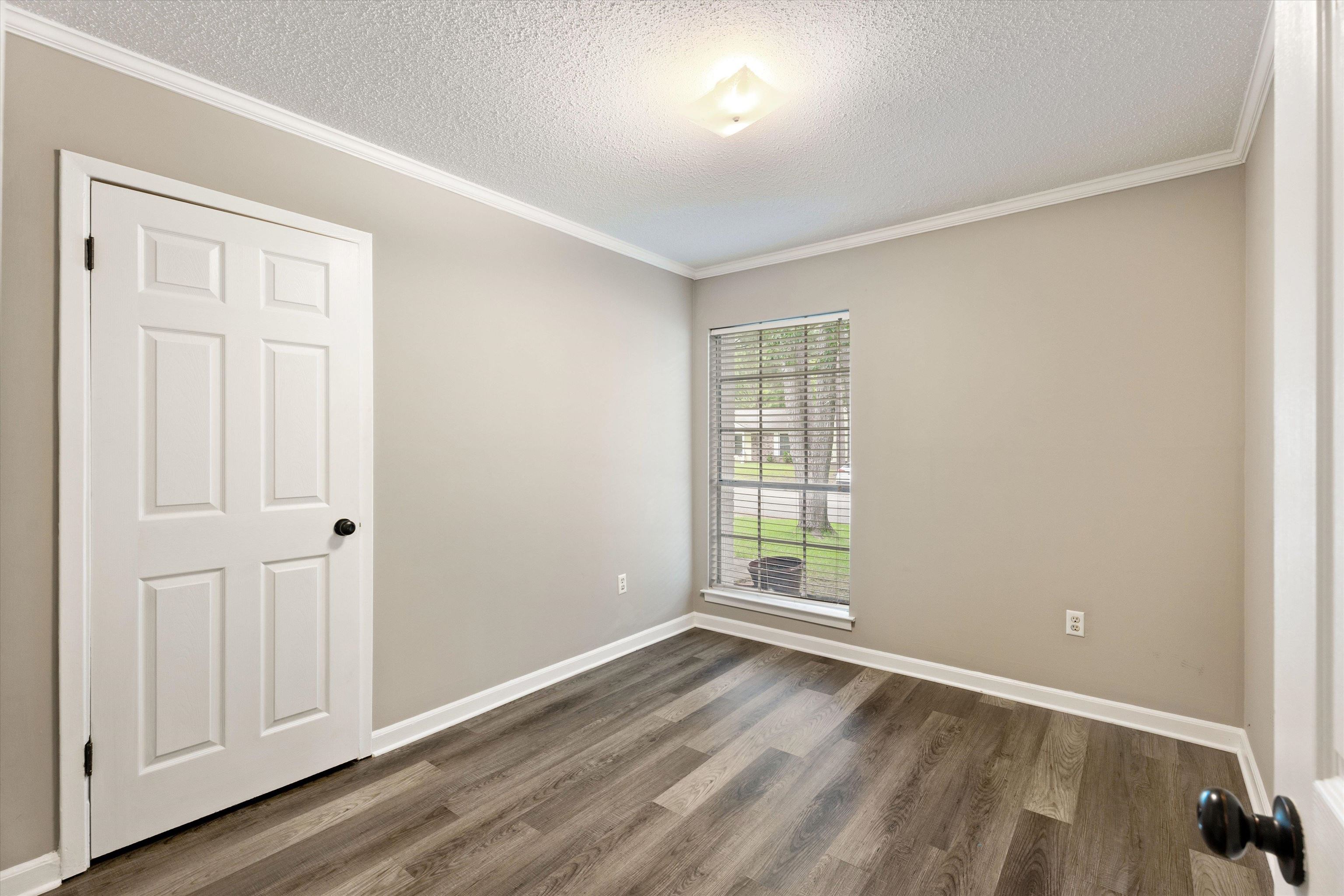 960 Greenview Road Collierville, TN 38017 - Photo 18 of 23 an empty room with wooden floor and windows