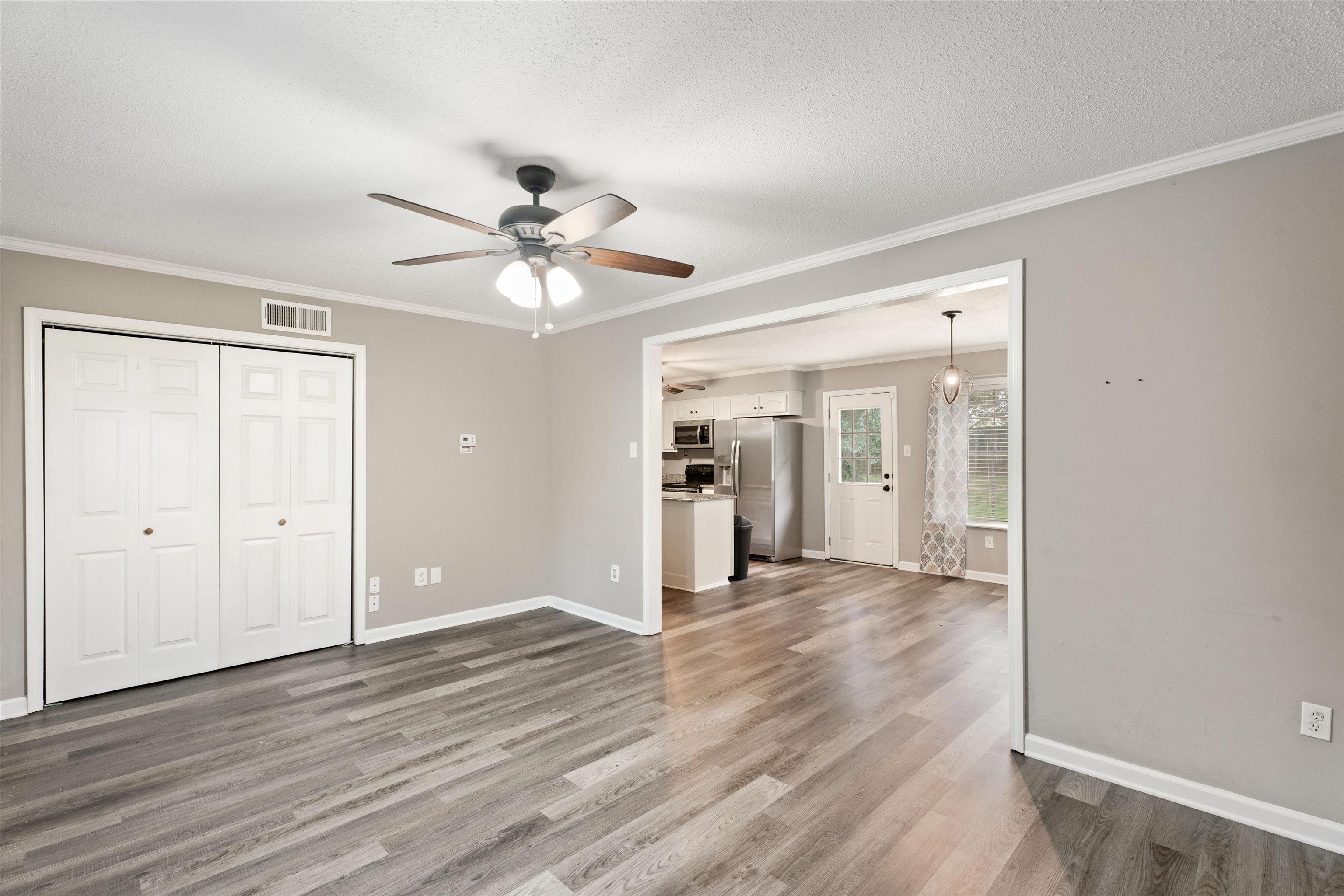 960 Greenview Road Collierville, TN 38017 - Photo 7 of 23 a view of a livingroom with wooden floor and a ceiling fan
