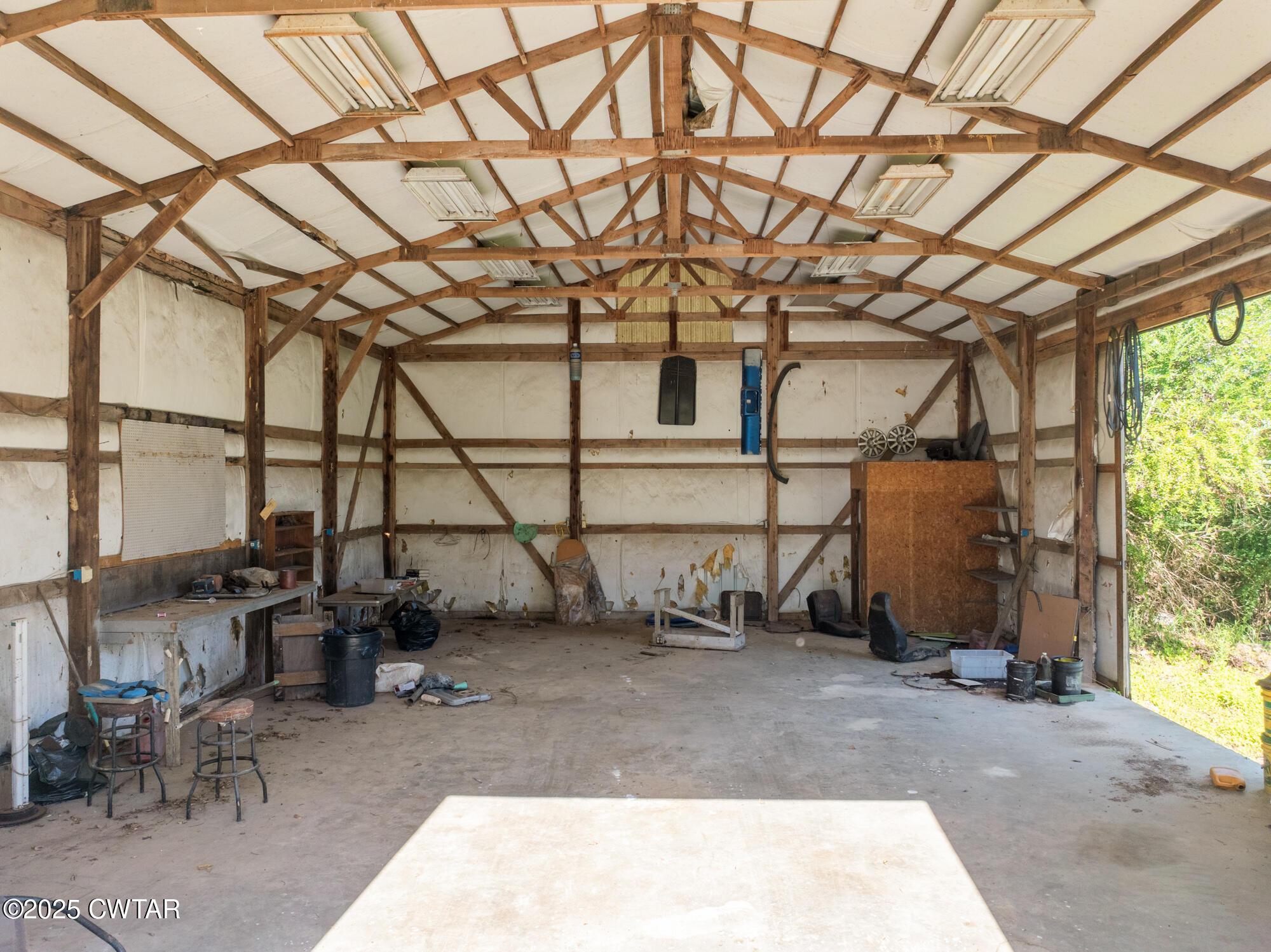 490 Maxwell Road Scotts Hill, TN 38374 - Photo 6 of 10 a backyard view with sitting space