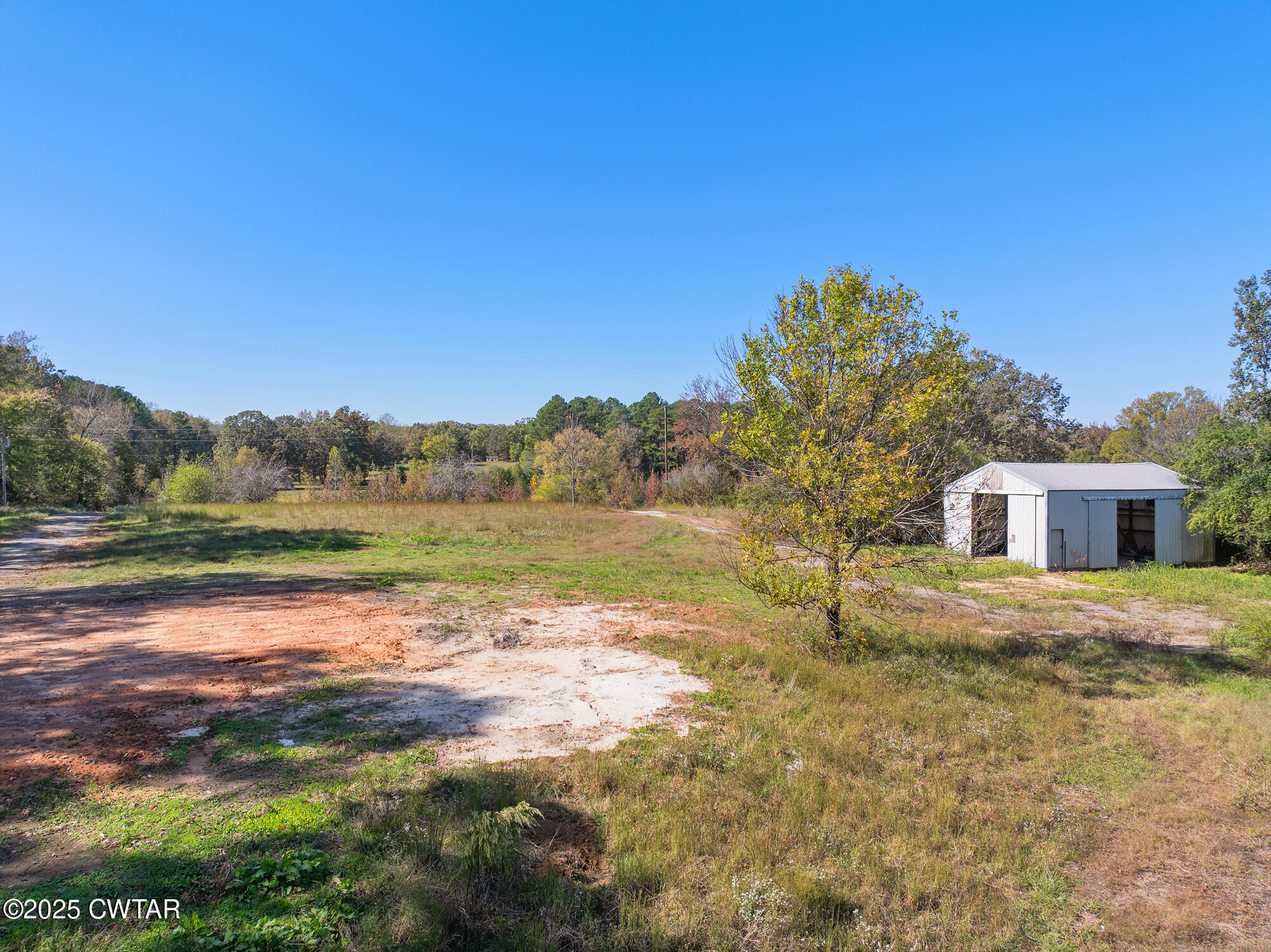 490 Maxwell Road Scotts Hill, TN 38374 - Photo 8 of 10 a view of a lake with a house in the background