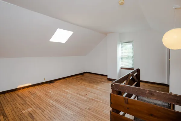a view of room with window and wooden floor