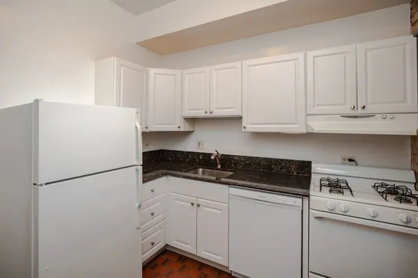 a white refrigerator freezer sitting inside of a kitchen