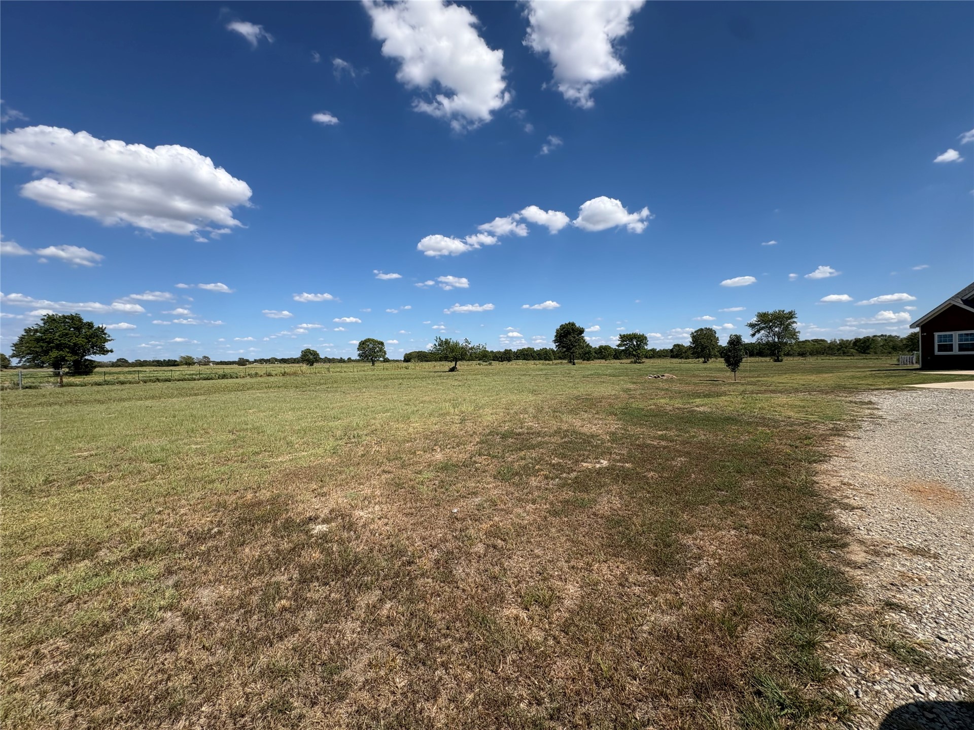313 Nauvoo Hills Road Caddo, OK 74729 - Photo 35 of 41 Expansive grassy lot with scattered mature trees and a gravel driveway