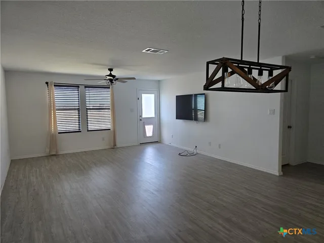 a view of a room with wooden floor staircase and windows
