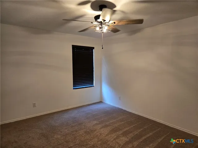 a view of a ceiling fan and wooden floor