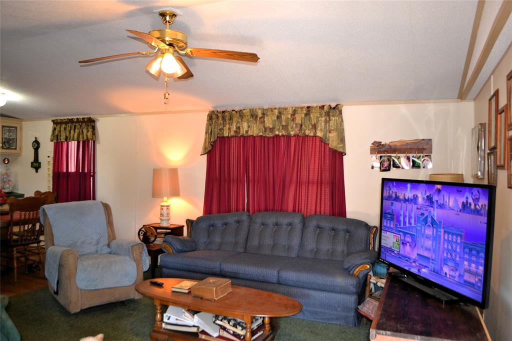 174 Kickapoo Quitman, TX 75783 - Photo 13 of 25 a living room with furniture a couch and a chandelier