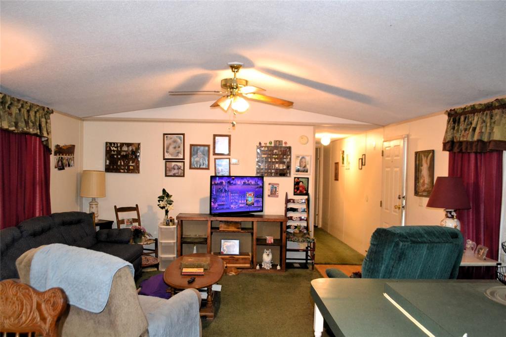 174 Kickapoo Quitman, TX 75783 - Photo 14 of 25 a living room with furniture a rug and a window
