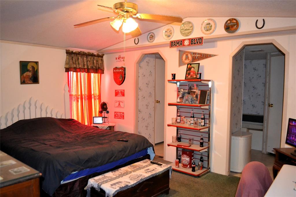 174 Kickapoo Quitman, TX 75783 - Photo 15 of 25 a bedroom with a bed and a chandelier