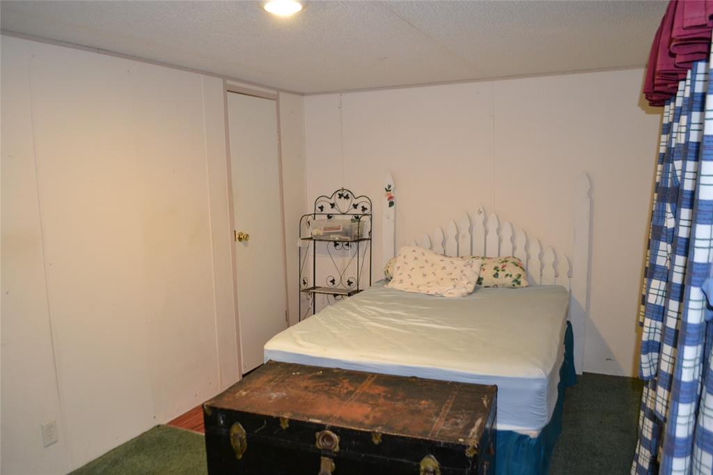 174 Kickapoo Quitman, TX 75783 - Photo 16 of 25 a bedroom with a table and a bed