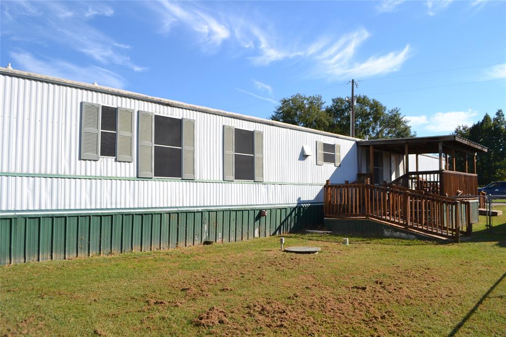 174 Kickapoo Quitman, TX 75783 - Photo 8 of 25 a backyard of a house with a garden