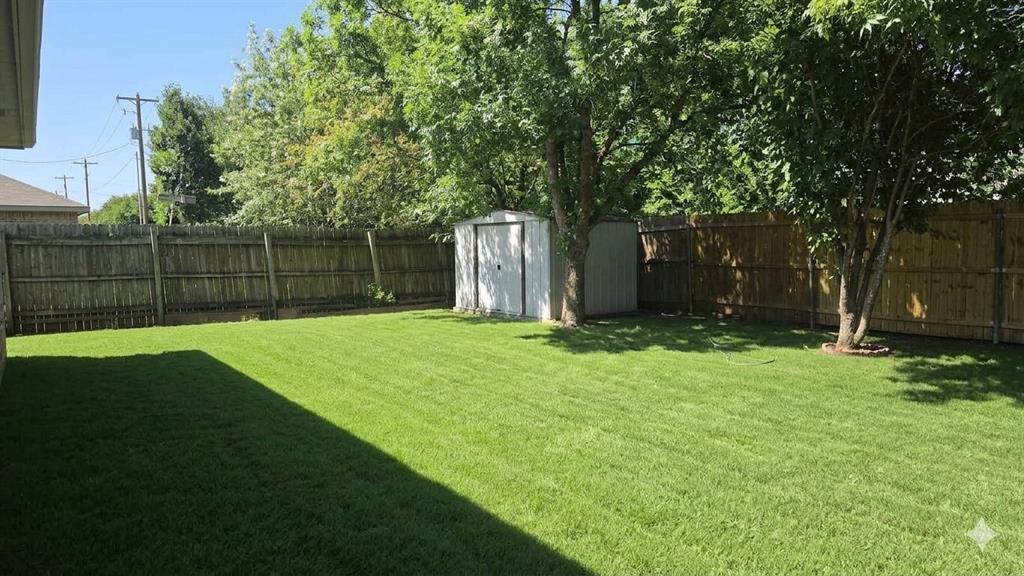 211 Vista Ridge Drive Venus, TX 76084 - Photo 22 of 24 Spacious backyard featuring a manicured lawn, established trees, and a wooden privacy fence