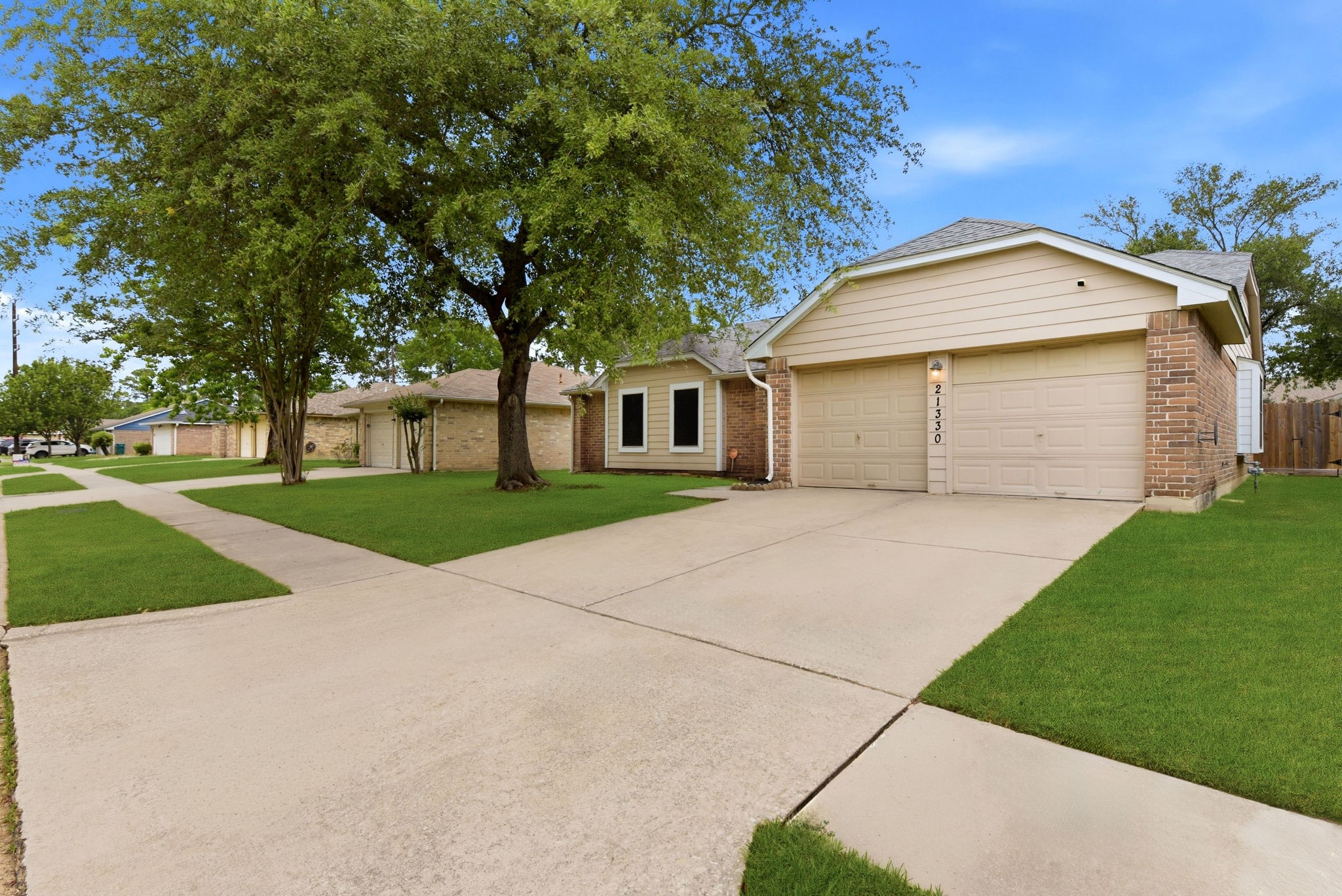21330 Golden Dove Drive Spring, TX 77388 - Photo 2 of 29 A wide driveway and classic two-car garage ensure you will always have plenty of parking for family and visiting guests.