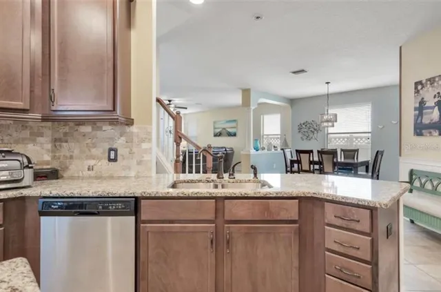 a kitchen with granite countertop a sink and cabinets