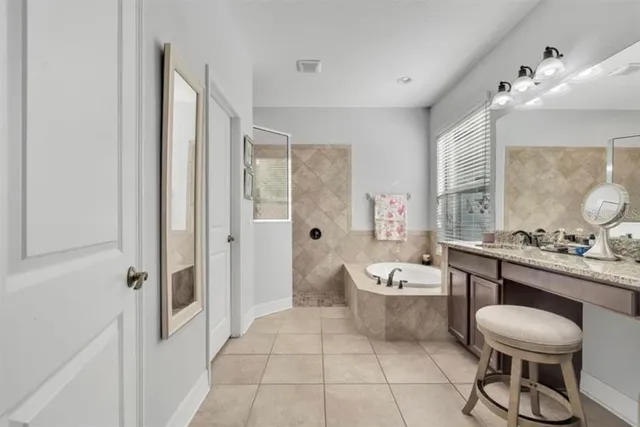 a spacious bathroom with a bathtub shower sink mirror and toilet