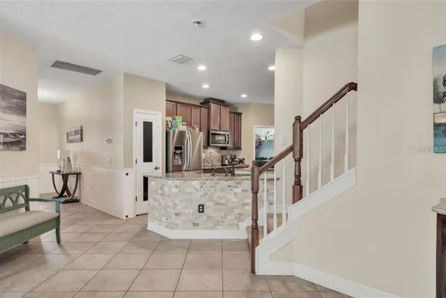 a view of kitchen with furniture and refrigerator
