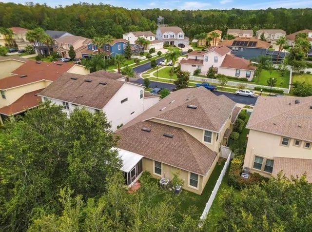 an aerial view of residential houses with outdoor space and river