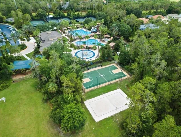 an aerial view of a residential houses with yard
