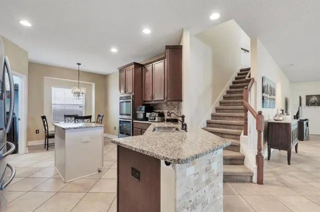 a kitchen with sink refrigerator and cabinets