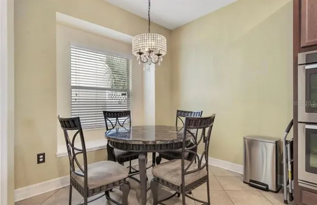 a view of a dining room with furniture and window