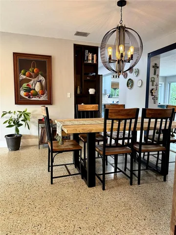 a view of a dining room with furniture and chandelier