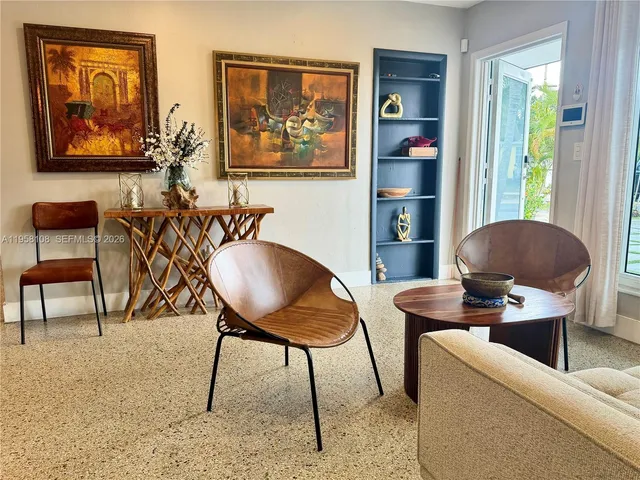 a work room with furniture and a painting