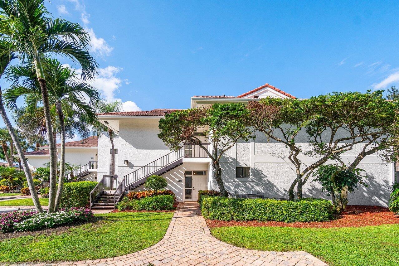 19173 Sabal Lake Drive, Unit 5155 Boca Raton, FL 33434 - Photo 1 of 33 a view of a house with a yard and potted plants