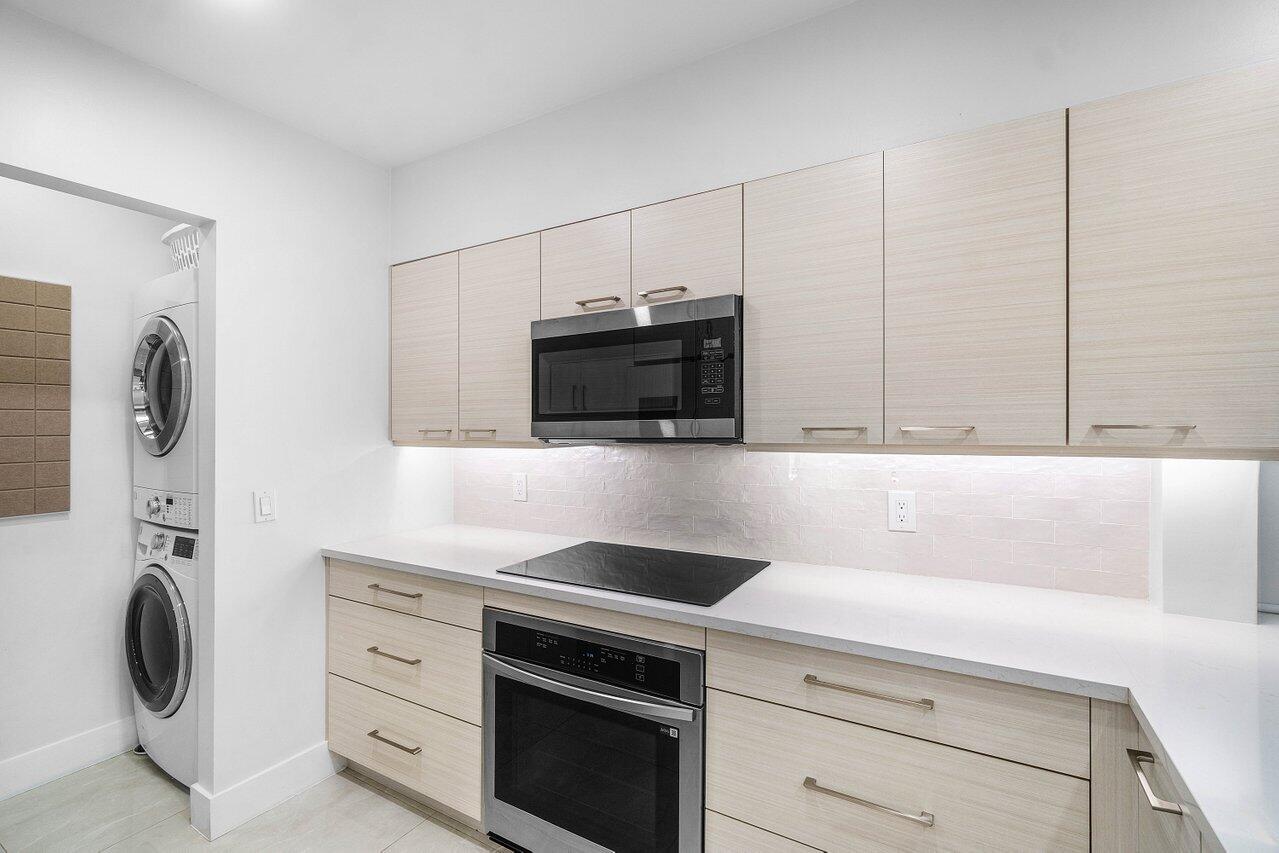 19173 Sabal Lake Drive, Unit 5155 Boca Raton, FL 33434 - Photo 12 of 33 a kitchen with a stove and a microwave