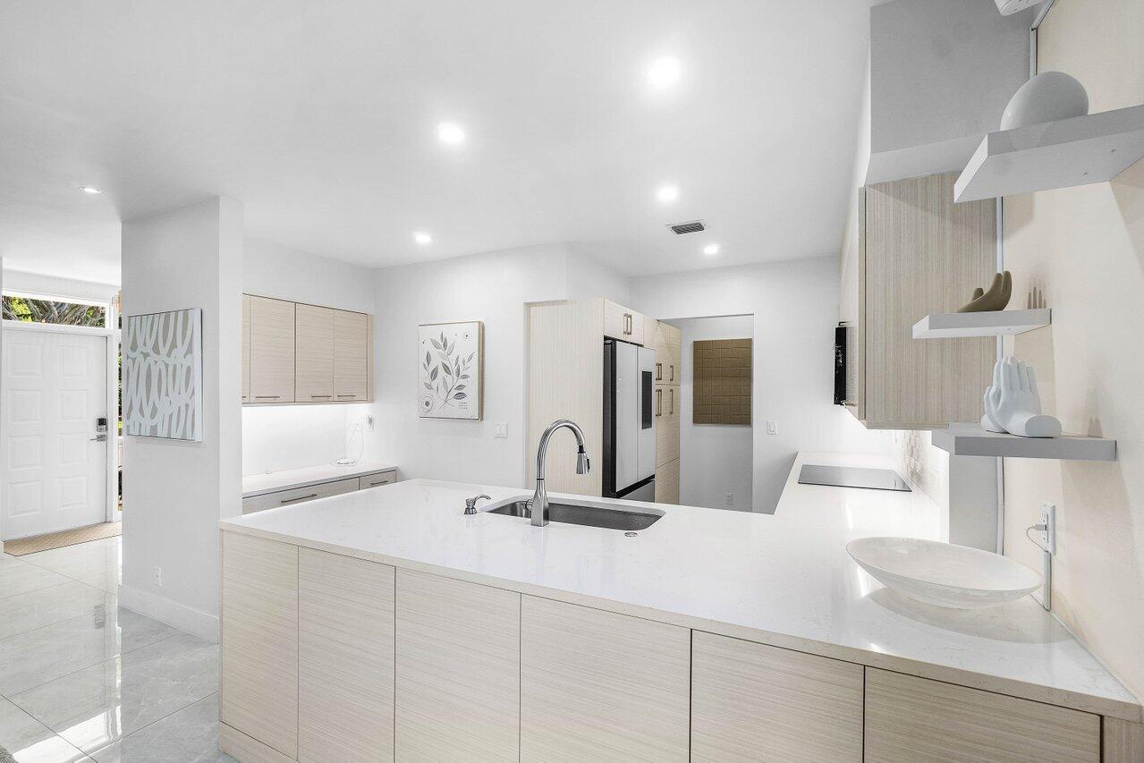 19173 Sabal Lake Drive, Unit 5155 Boca Raton, FL 33434 - Photo 15 of 33 a bathroom with a double vanity sink and a mirror