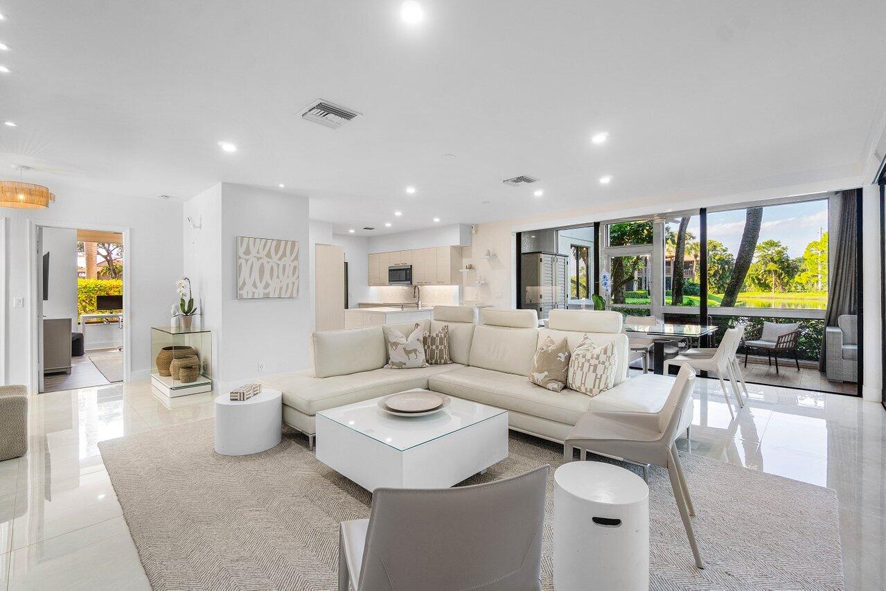 19173 Sabal Lake Drive, Unit 5155 Boca Raton, FL 33434 - Photo 2 of 33 a living room with furniture and a large window