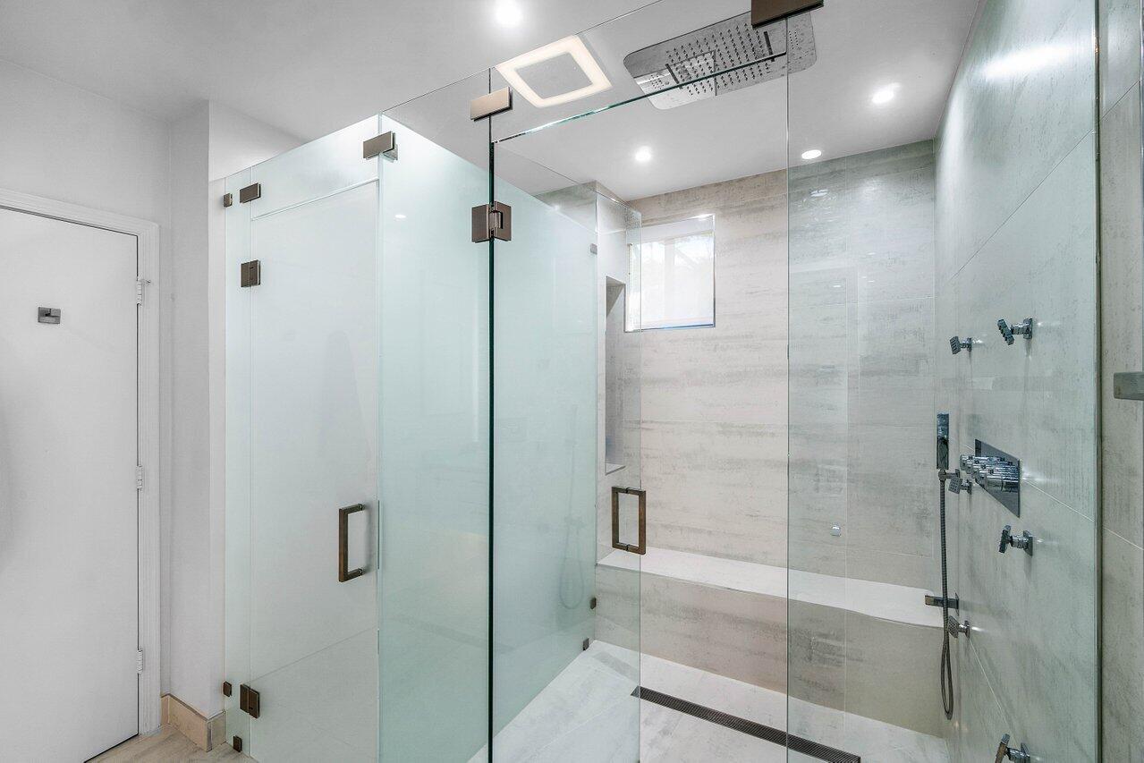 19173 Sabal Lake Drive, Unit 5155 Boca Raton, FL 33434 - Photo 21 of 33 a bathroom with a shower and a glass door