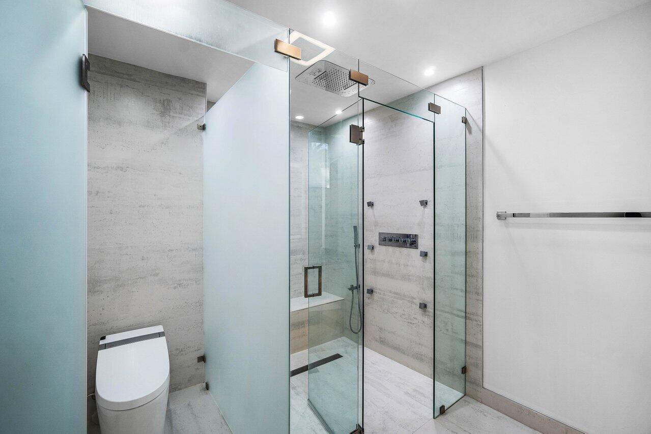 19173 Sabal Lake Drive, Unit 5155 Boca Raton, FL 33434 - Photo 22 of 33 a bathroom with a shower and a toilet