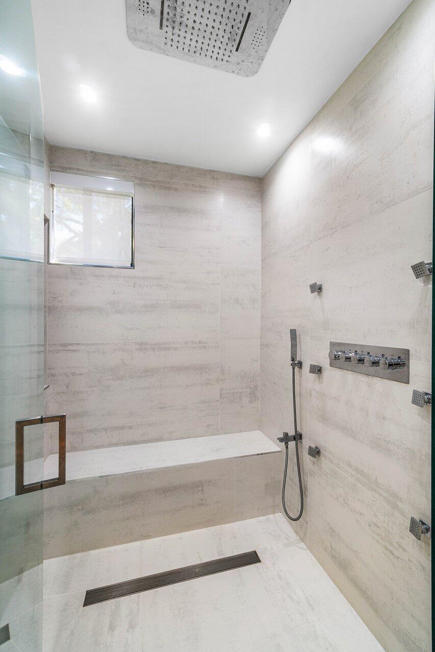 19173 Sabal Lake Drive, Unit 5155 Boca Raton, FL 33434 - Photo 23 of 33 a bathroom with a shower