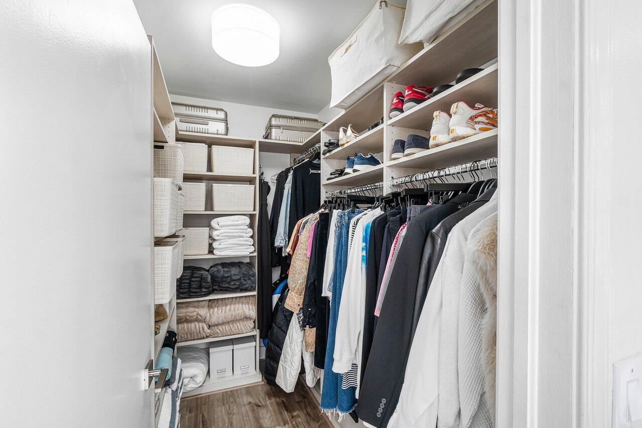 19173 Sabal Lake Drive, Unit 5155 Boca Raton, FL 33434 - Photo 26 of 33 a view of walk in closet with clothes and shoes