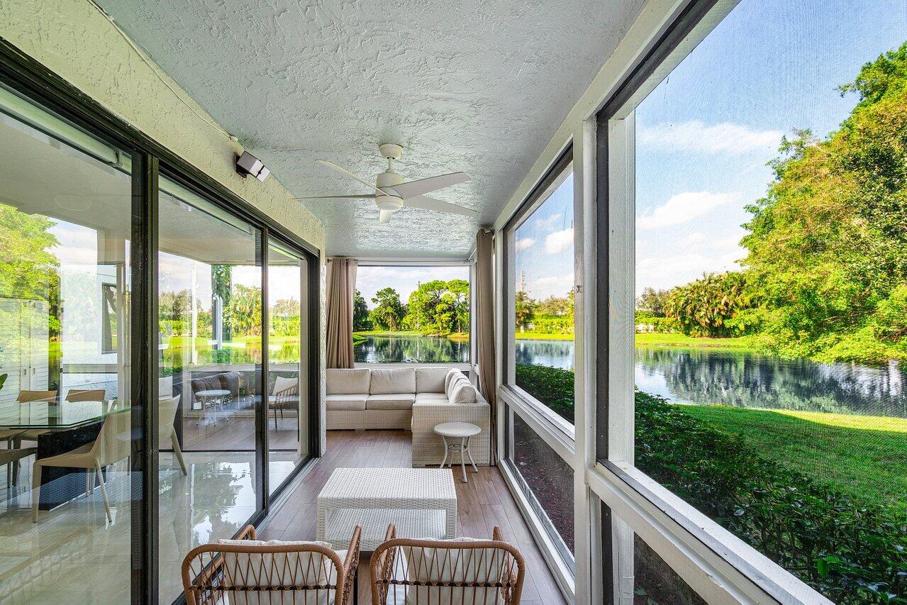 19173 Sabal Lake Drive, Unit 5155 Boca Raton, FL 33434 - Photo 28 of 33 a view of a porch with furniture and garden