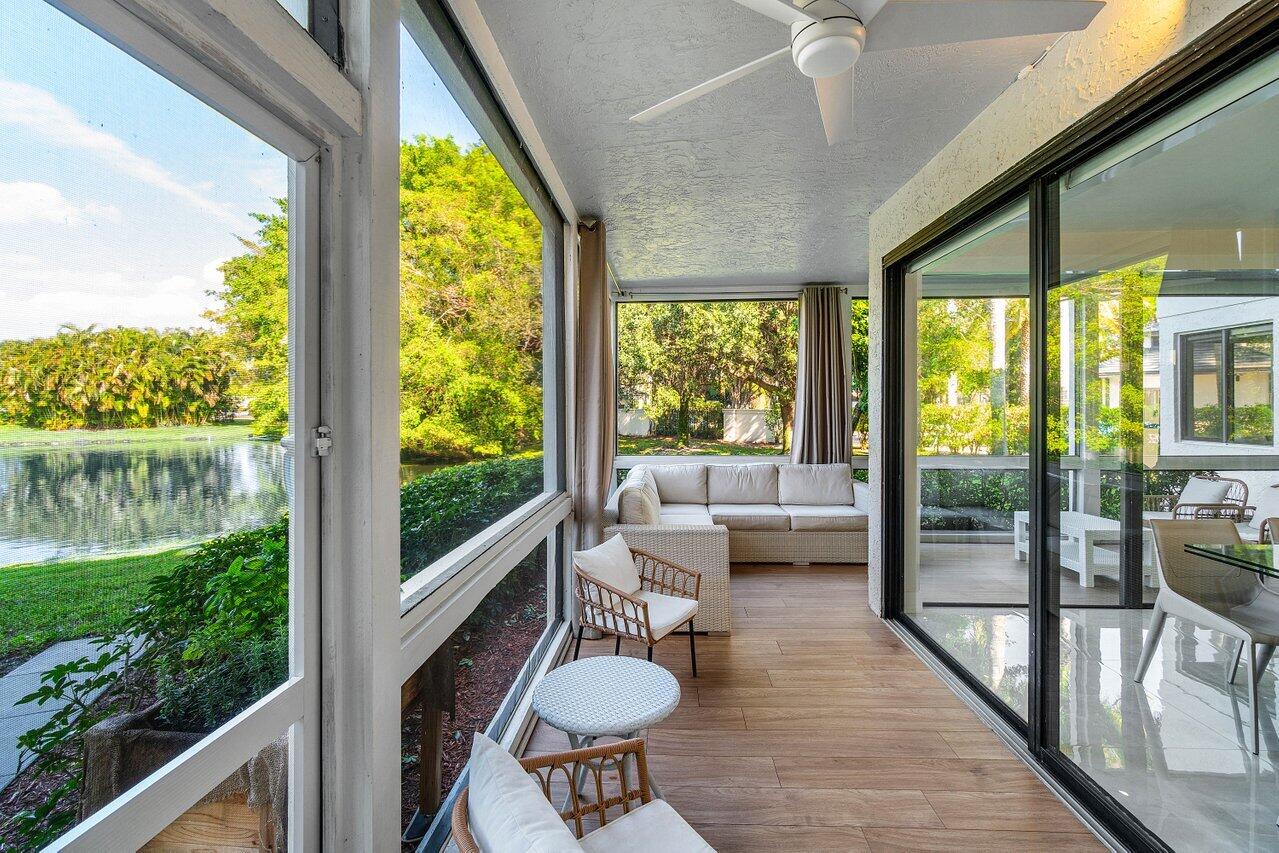 19173 Sabal Lake Drive, Unit 5155 Boca Raton, FL 33434 - Photo 29 of 33 a balcony with furniture and wooden floor