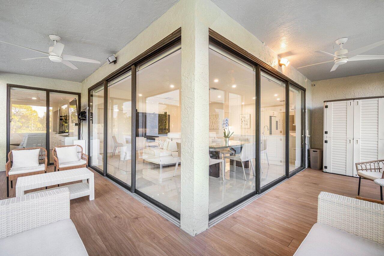 19173 Sabal Lake Drive, Unit 5155 Boca Raton, FL 33434 - Photo 30 of 33 a living room with furniture and a large window