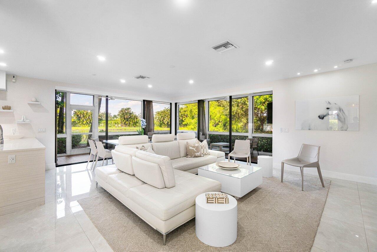 19173 Sabal Lake Drive, Unit 5155 Boca Raton, FL 33434 - Photo 3 of 33 a living room with furniture and a large window