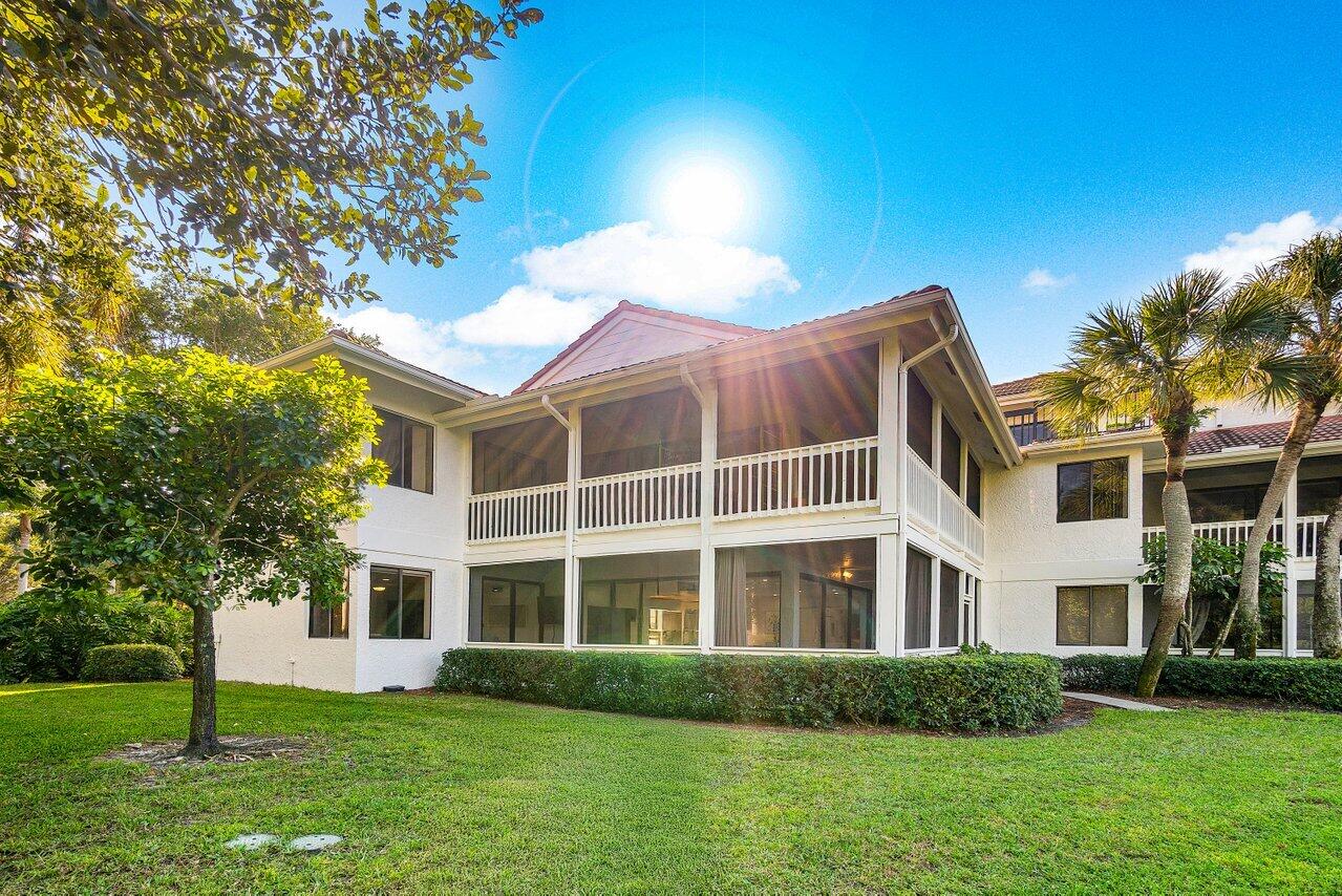 19173 Sabal Lake Drive, Unit 5155 Boca Raton, FL 33434 - Photo 32 of 33 a front view of a house with a garden