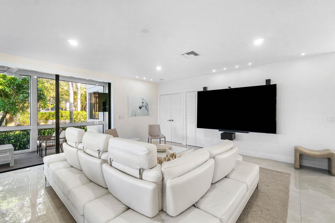 19173 Sabal Lake Drive, Unit 5155 Boca Raton, FL 33434 - Photo 4 of 33 a living room with furniture and a flat screen tv