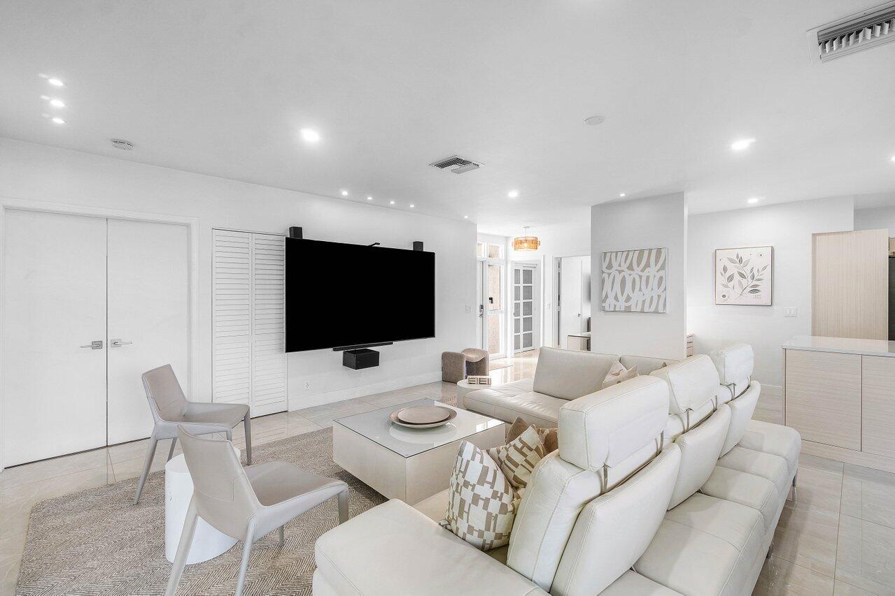 19173 Sabal Lake Drive, Unit 5155 Boca Raton, FL 33434 - Photo 5 of 33 a living room with furniture and a flat screen tv